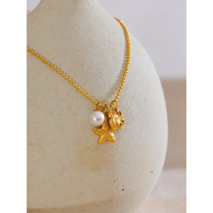 Collier à Breloques Perle, Étoile et Crabe Doré